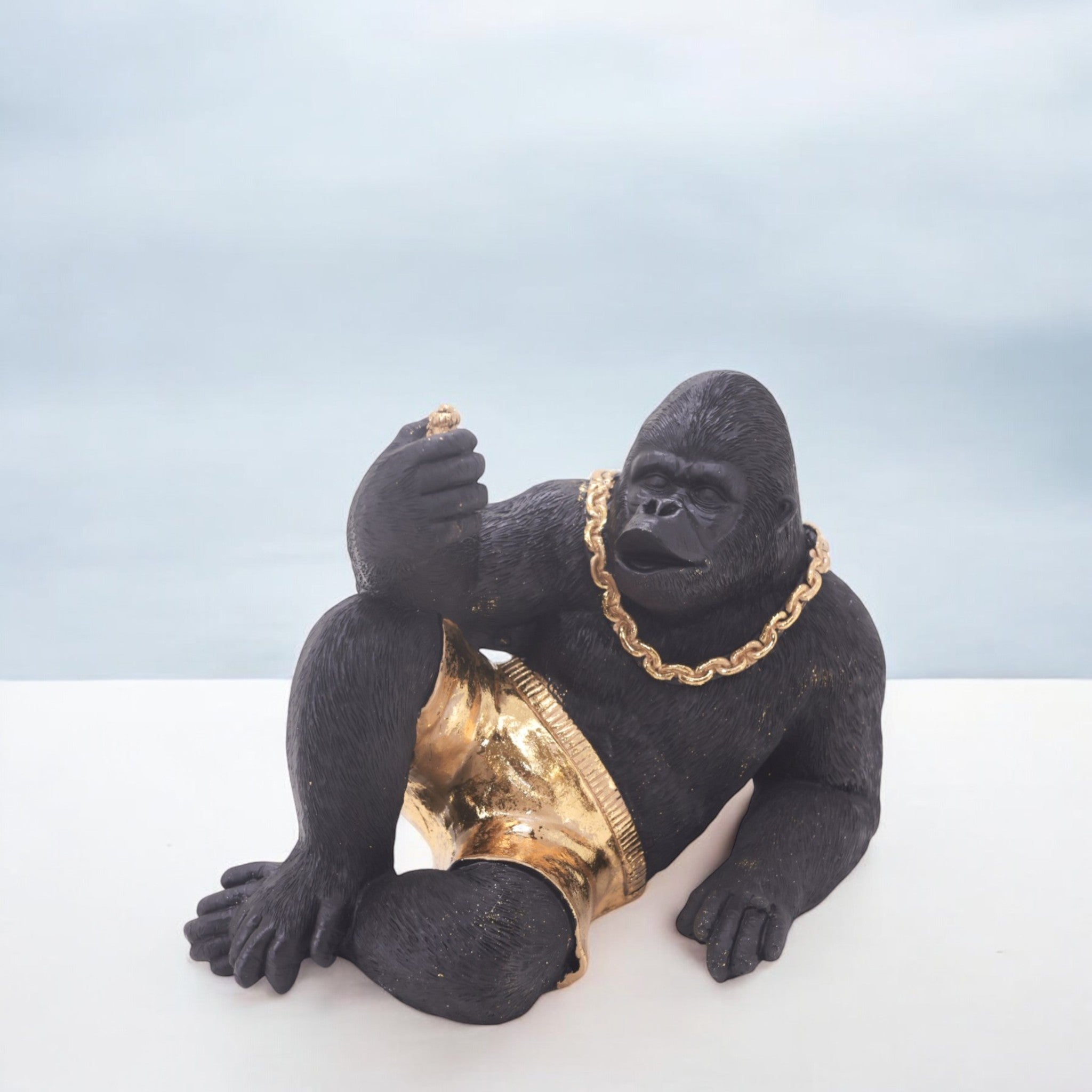 Modern Lounging Gorilla Sculpture | Black & Gold Urban Art Statue | 28.5cm Contemporary Home Decor - Divine Dekor